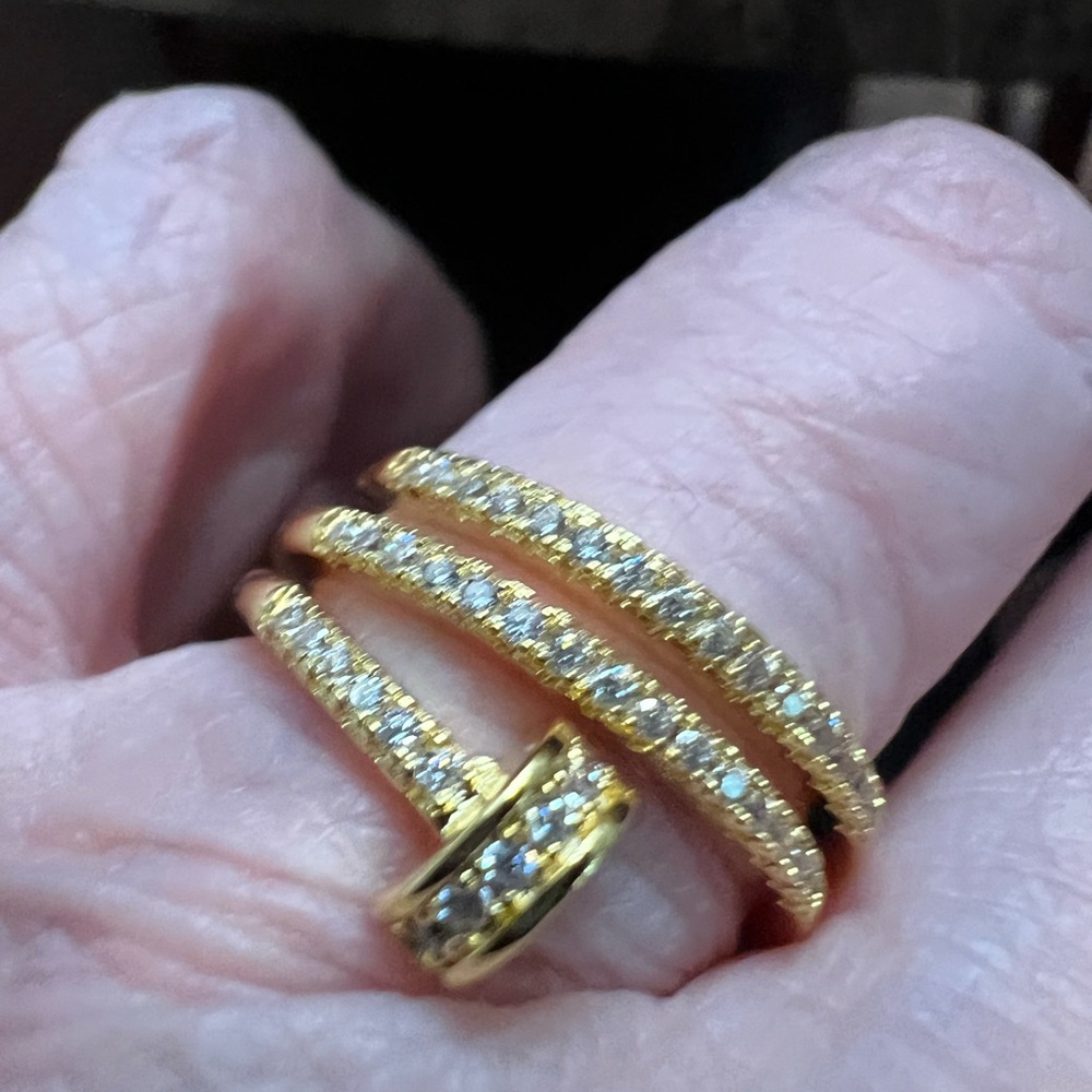 Nail ring size small CZ all around and it’s very different color is Brass gold.